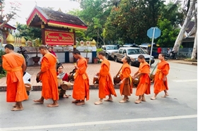 THE ALMS GIVING CEREMONY IN LUANG PRABANG